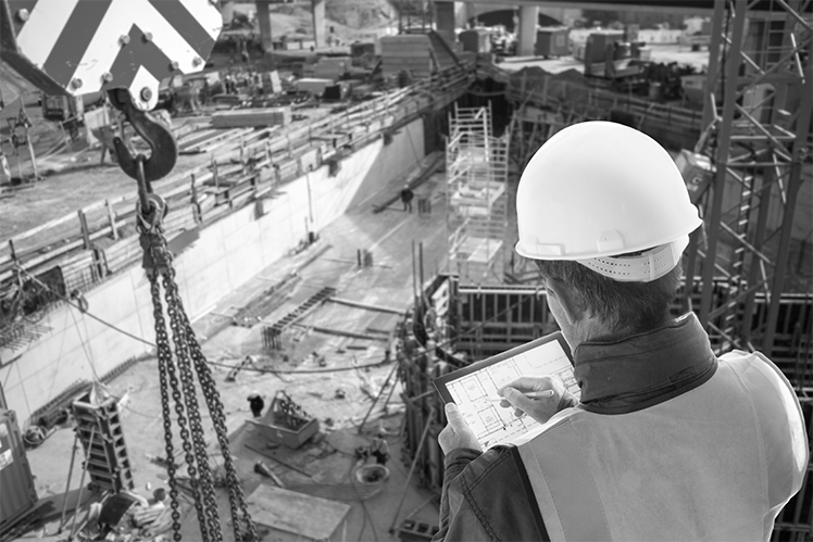 engineer on consruction site with tablet computer checking building plan2